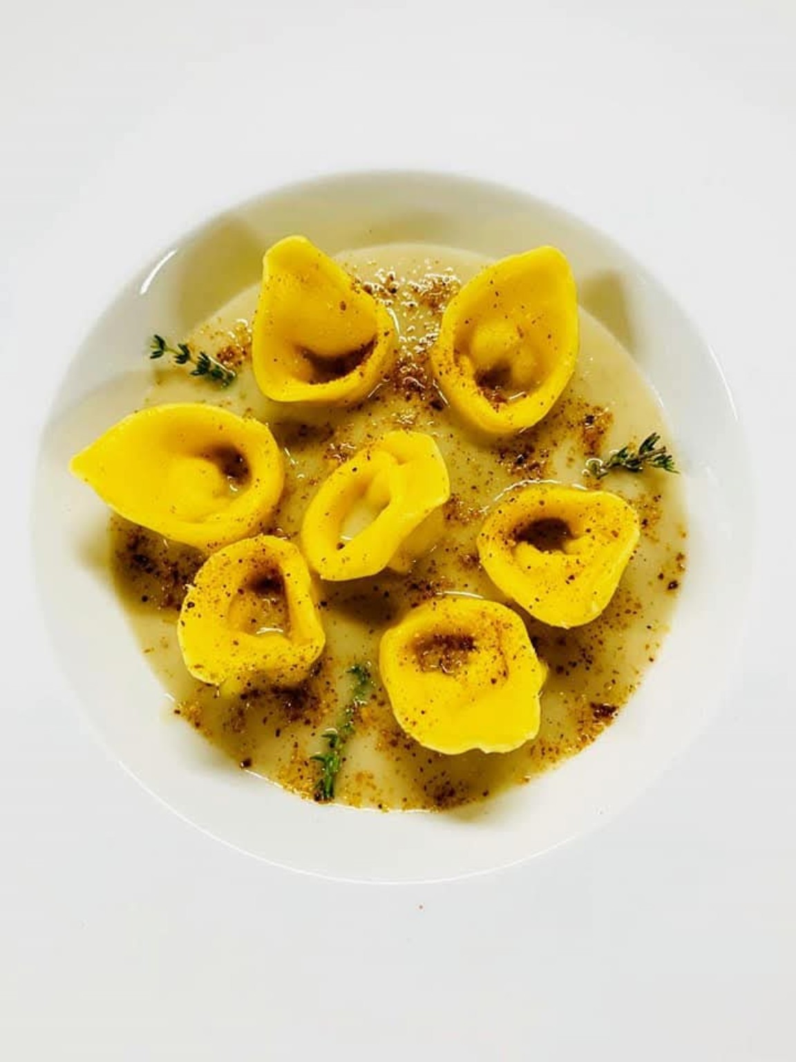 Chef finishing a handmade pasta dish